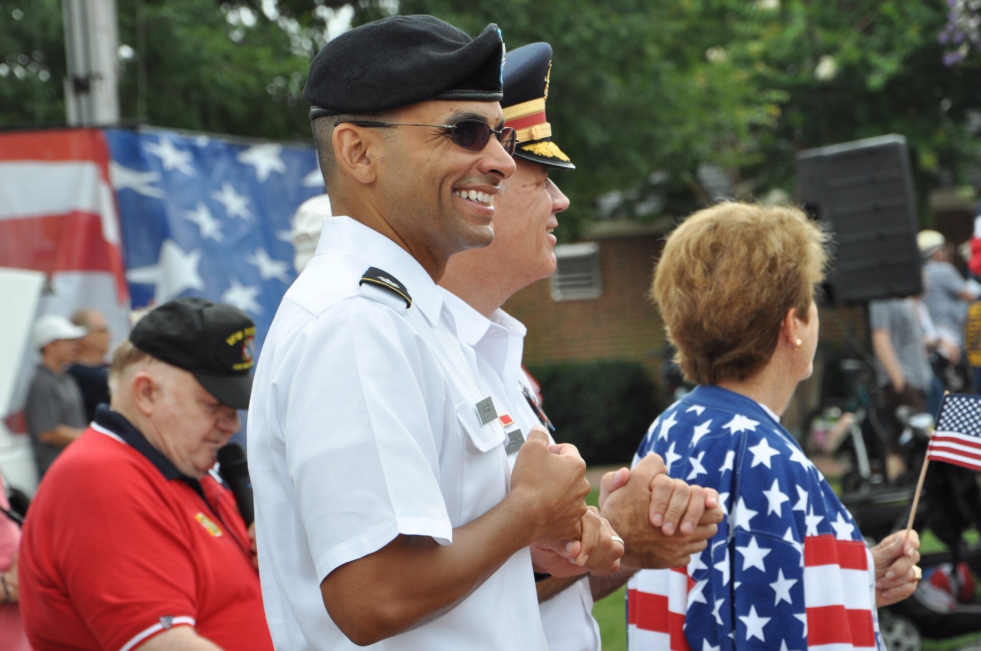 U.S. Army Lt. Col. Ricardo L. Sierra-Guzman, left, Fort Eustis-Story Army Support Activity commander, and U.S. Army Col. William Galbraith, 733rd Mission Support Group commander watch as color guards, marching units, parade vehicles and representatives from various organizations pass by during a parade in Yorktown, Va. July 4, 2015.   The parade was part of the 35th Annual Yorktown Fourth of July Celebration, during which several events took place to Celebrate America’s independence.  (U.S. Air Force photo by Master Sgt. April Wickes/Released) 