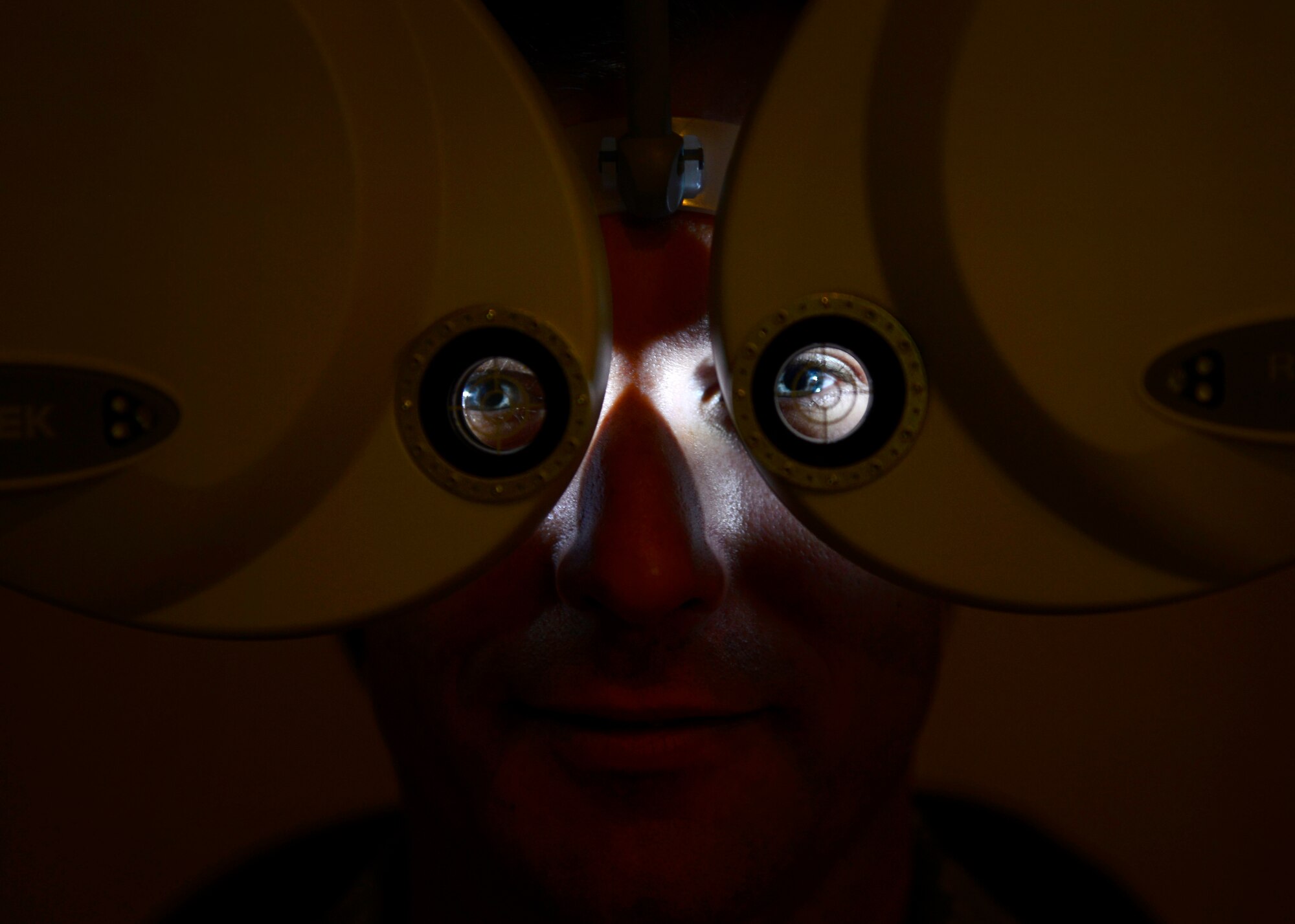U.S. Air Force Tech. Sgt. Joel Ives, 31st Aerospace Medicine Squadron optometry NCOIC, gets his eyes tested, July 7, 2015, at Aviano Air Base, Italy. The optometry clinic conducts 300 eye exams every month. They check for any changes in each patient’s eyesight and perform procedures to identify any diseases a patient may have at the earliest stage possible.  (U.S. Air force photo by Senior Airman Areca T. Wilson/Released)