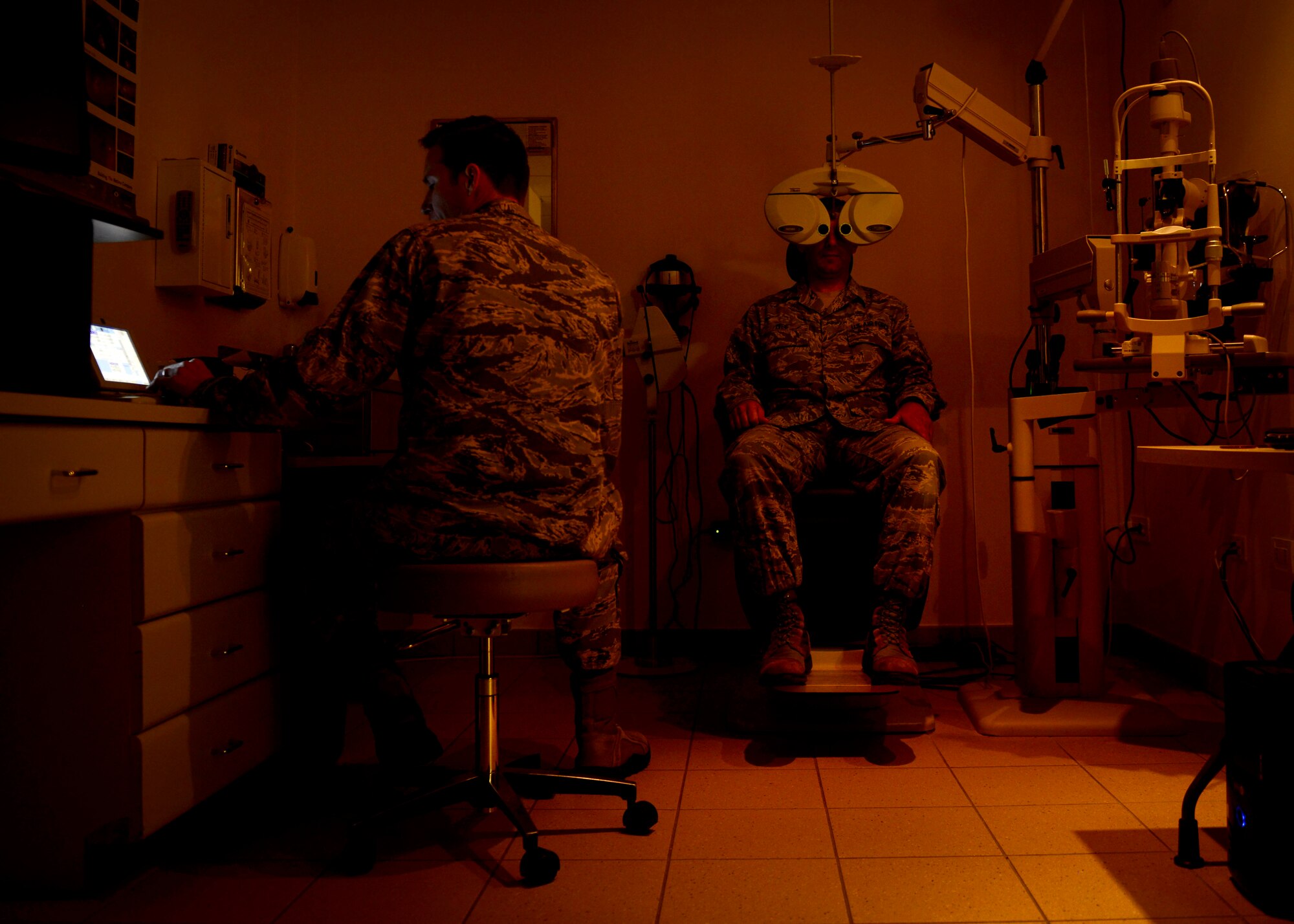 U.S. Air Force Capt. Sean Berensen, 31st Aerospace Medicine Squadron optometrist, tests a patient’s eyes, July 7, 2015, at Aviano Air Base, Italy. The optometry clinic uses a phoropter, which contains different lenses, to determine a patient’s glasses prescription. (U.S. Air force photo by Senior Airman Areca T. Wilson/Released)