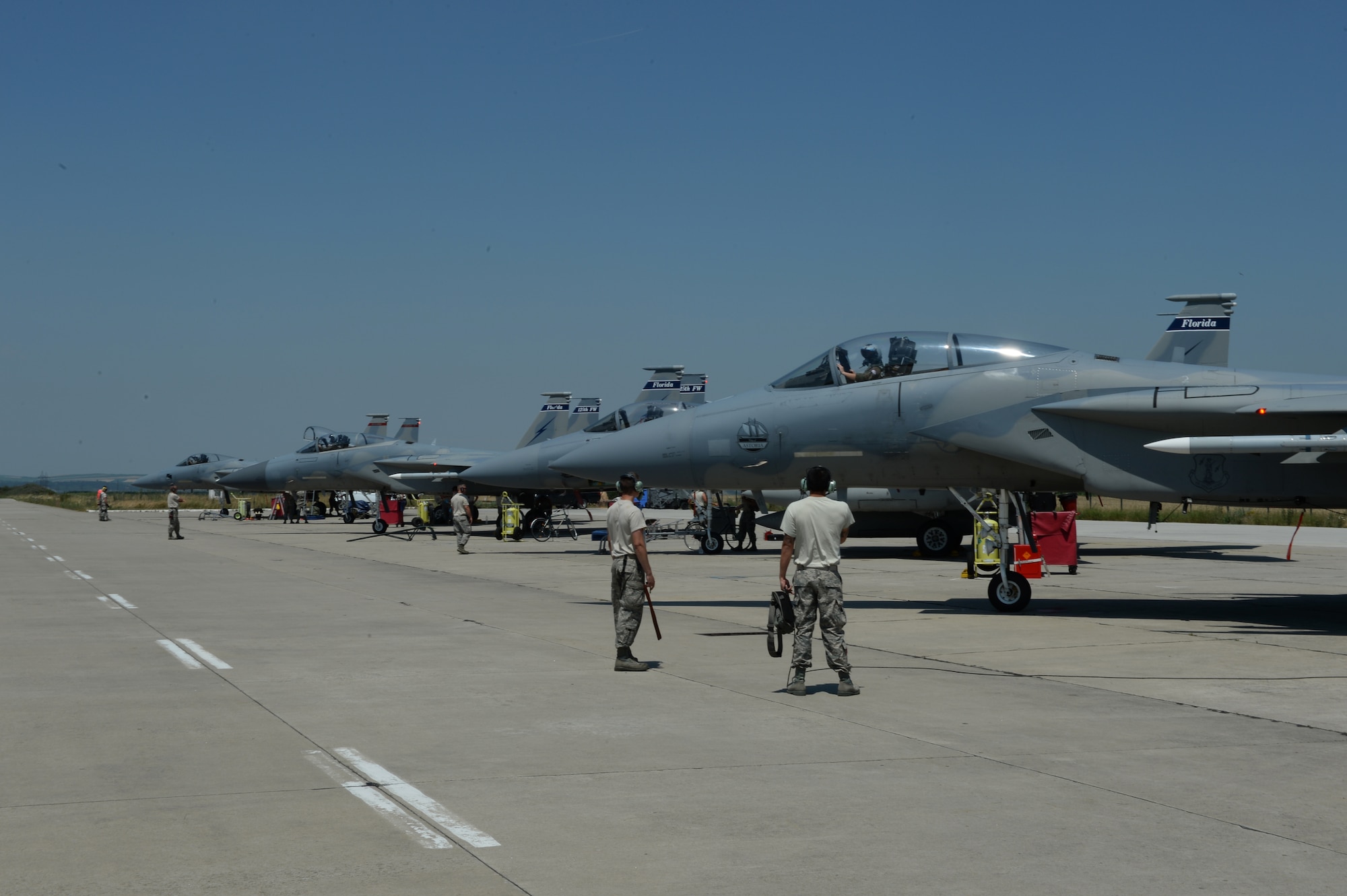 A group of U.S. Air National Guard F-15C Eagle fighter aircraft assigned to the 123rd Expeditionary Fighter Squadron wait to taxi from the flightline during a theater security package deployment July 6, 2015, at Campia Turzii, Romania. The U.S. values the shared commitment and close cooperation with NATO partners on the security and stability of Europe. (U.S. Air Force photo by Senior Airman Dylan Nuckolls/Released)