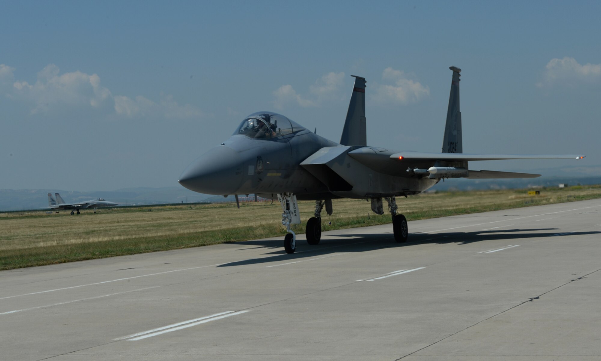 A U.S. Air National Guard F-15C Eagle fighter aircraft pilot assigned to the 123rd Expeditionary Fighter Squadron taxis during a theater security package deployment July 6, 2015, at Campia Turzii, Romania. The U.S. and Romanian air forces will conduct training aimed to strengthen interoperability and demonstrate the countries' shared commitment to the security and stability of Europe. (U.S. Air Force photo by Senior Airman Dylan Nuckolls/Released)
