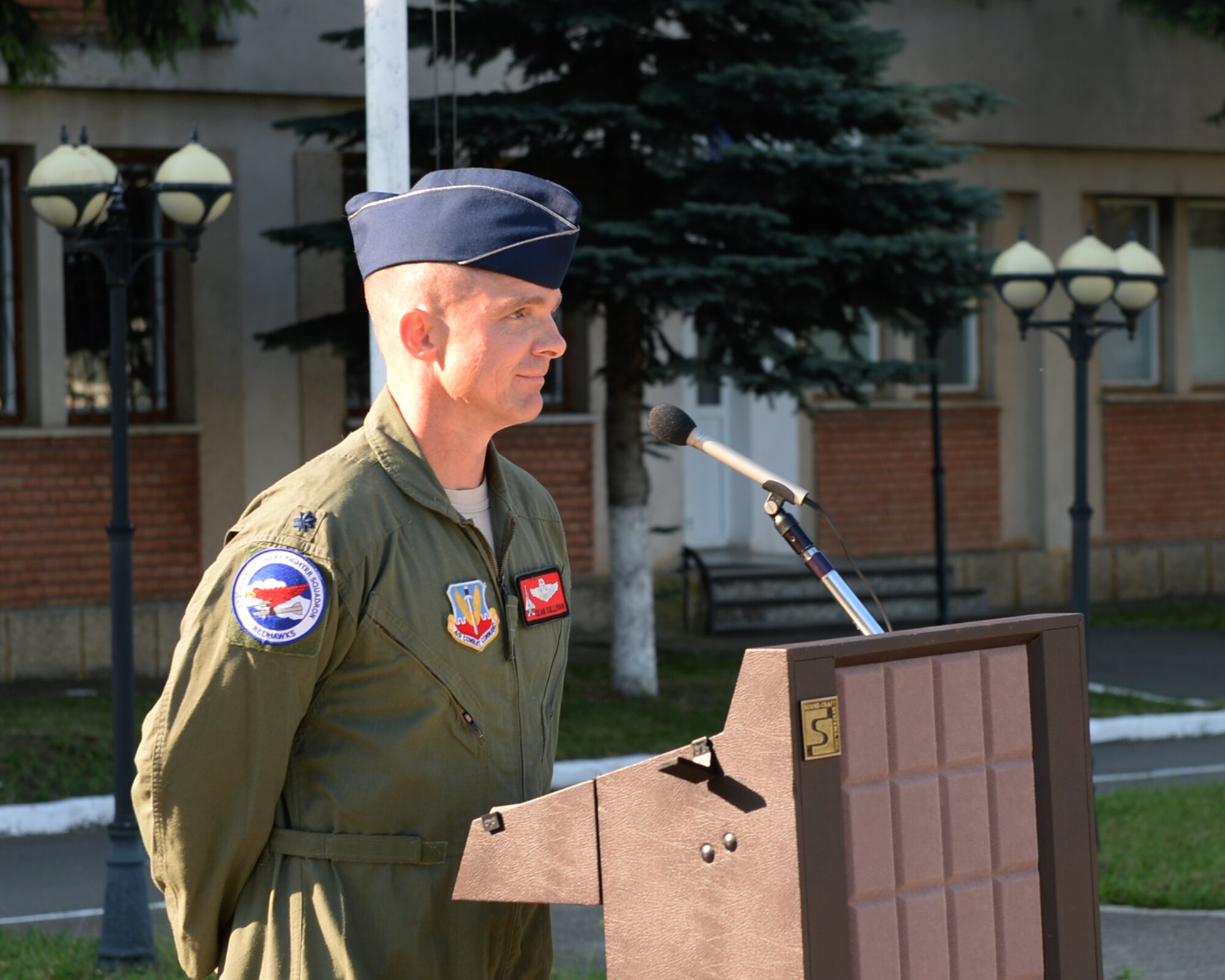 U.S. Air National Guard Lt. Col. Sean Sullivan, 123rd Expeditionary Fighter Squadron commander, speaks during an opening ceremony July 6, 2015, at Campia Turzii, Romania. The Romanian air force hosted the ceremony to signal the start of the training between the two countries as part of a European theater security package of F-15C Eagle fighter aircraft deployed to Romania. (U.S. Air Force photo by Senior Airman Dylan Nuckolls/Released)