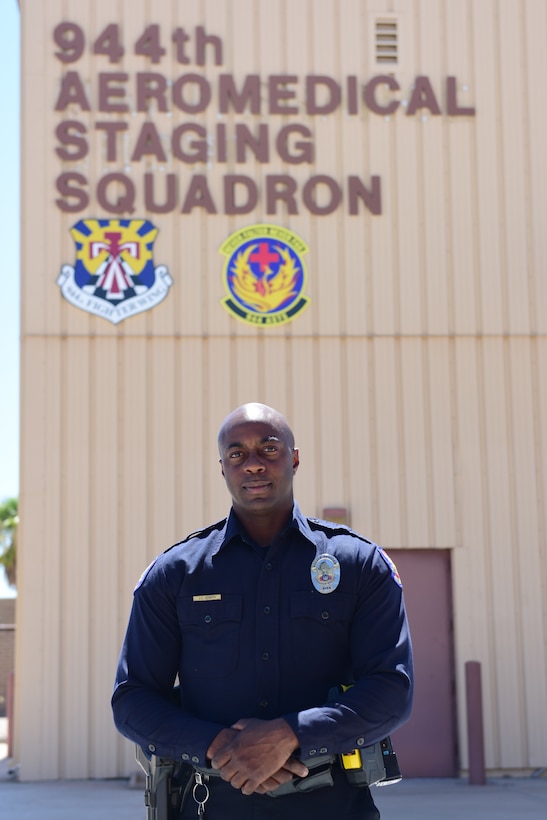 Air Force Tech. Sgt. Jude Joseph, 944th Aeromedical Staging Squadron medical technician and eight-year veteran of the Phoenix Police Department, poses in front of the 944th ASTS building July 8, 2015. Joseph, an Air Force Reservist, was the first police officer to respond when two children were found at a bottom of a swimming pool July 2. U.S. Air Force photo by Staff Sgt. Lausanne Kinder