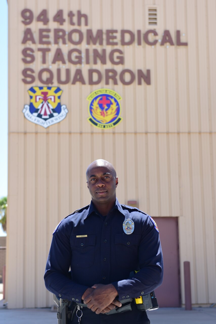Air Force Tech. Sgt. Jude Joseph, 944th Aeromedical Staging Squadron medical technician and eight-year veteran of the Phoenix Police Department, poses in front of the 944th ASTS building July 8, 2015. Joseph, an Air Force Reservist, was the first police officer to respond when two children were found at a bottom of a swimming pool July 2. U.S. Air Force photo by Staff Sgt. Lausanne Kinder