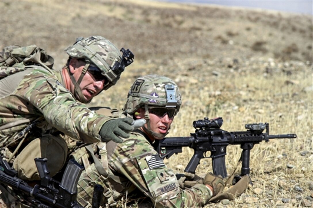 U.S. Army Staff Sgt. Brown, left directs U.S. Army Spc. Warren toward his next objective during a live-fire exercise on Tactical Base Gamberi, Afghanistan, July 3, 2015. Brown and Warren are assigned to the 101st Airborne Division's 3rd Brigade Combat Team.