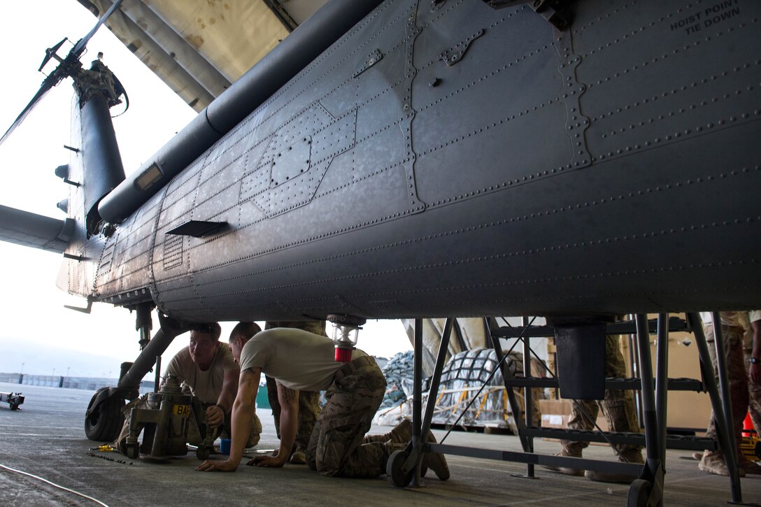 U.S. Air Force Senior Airman Joseph Roberts and U.S. Air Force Airman 1st Class Trevor Krutsch complete a 50-hour inspection of an HH-60 Pave Hawk helicopter on Bagram Airfield, Afghanistan, June 28, 2015. Roberts and Krutsch are crew chiefs assigned to the 41st Expeditionary Helicopter Maintenance Unit.