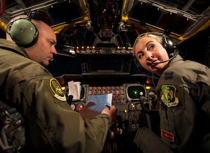 U.S. Air Force Lt. Col. Monte Wiley (left), 69th Bomb Squadron pilot, and U.S. Air Force Capt. Kristin Nelson, 23rd Bomb Squadron pilot, conduct pre-flight procedures in a B-52 Stratofortress before departing from Minot Air Force Base, N.D., for a 16-hour, non-stop mission to Colombia, July 9, 2015. During the mission to the U.S. Southern Command (USSOUTHCOM) area of responsibility, which was closely coordinated with the Colombian Ministry of National Defense, the B-52 will join up with aircraft from the Colombian Air Force to practice common aerial tactics and procedures before conducting a flyover demonstration at the Feria Aeronautica Internacional Rionegro (F-AIR) Colombia 2015 International Air Show. USSTRATCOM is one of nine DoD unified combatant commands and is charged with strategic deterrence; space operations; cyberspace operations; joint electronic warfare; global strike; missile defense; intelligence, surveillance and reconnaissance; combating weapons of mass destruction; and analysis and targeting. (U.S. Air Force photo by Senior Airman Stephanie Morris)