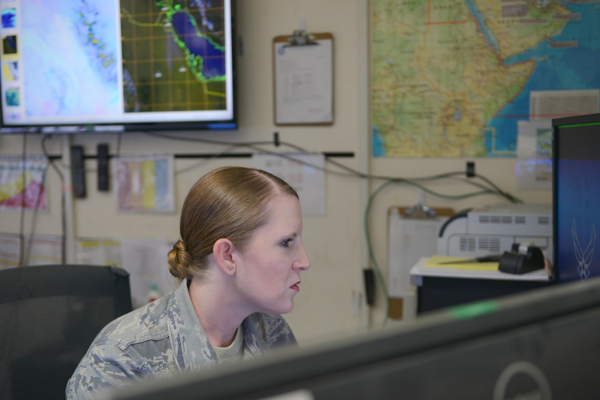 Tech. Sgt Vanessa Gonzales, 379th Expeditionary Operations Support Squadron  weather forecaster, checks the radar systems to assist U.S. and Coalition service members conduct daily operations safely July 8, 2015 Al Udeid Air Base, Qatar.