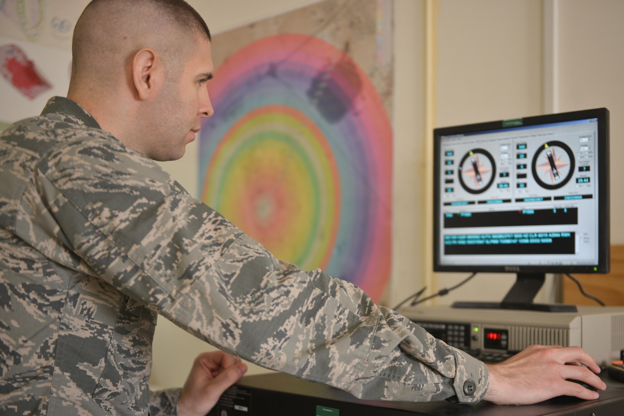 Capt. Kevin Eaton, 379th Expeditionary Operations Support Squadron, monitors wind speed and current patterns to construct a weather update for base personnel July 8, 2015 Al Udeid Air Base, Qatar.  