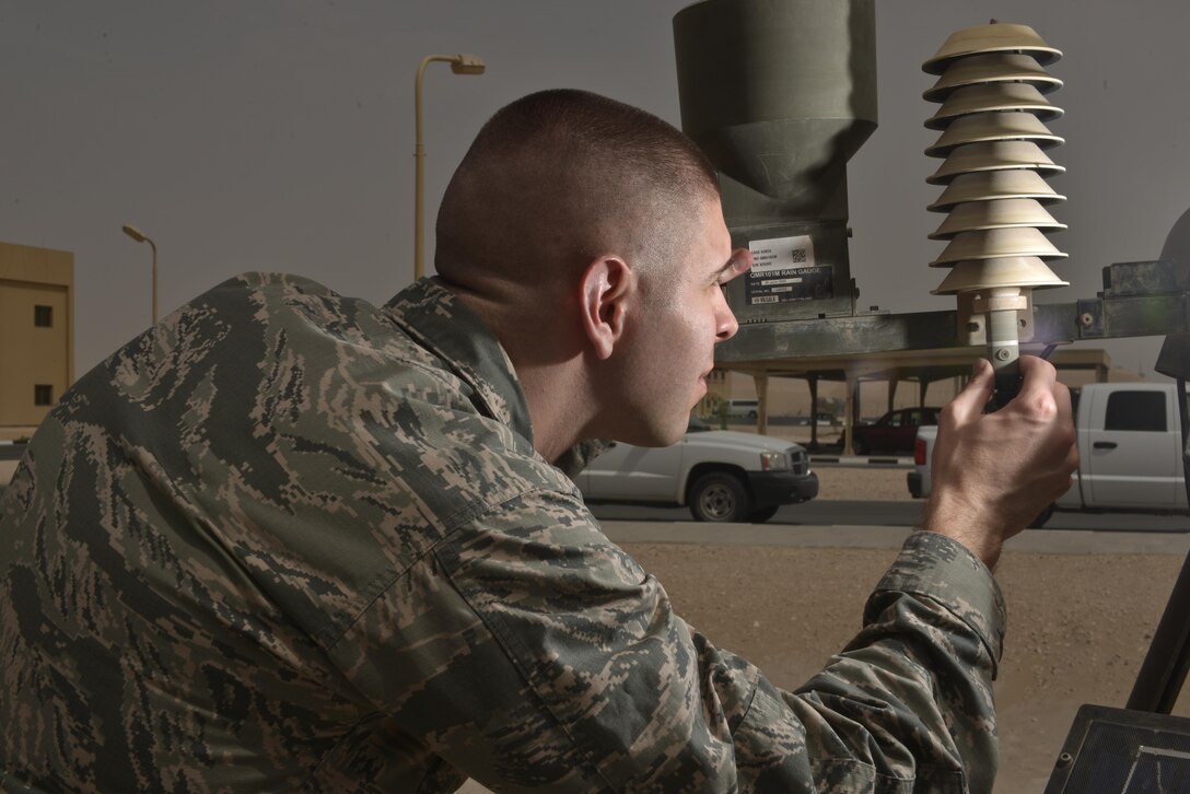 Capt. Kevin Eaton, 379th Expeditionary Operations Support Squadron, looks for wear and tear on a Tactical Meteorological Observing Sensor during a daily function check July 8, 2015 Al Udeid Air Base, Qatar.  