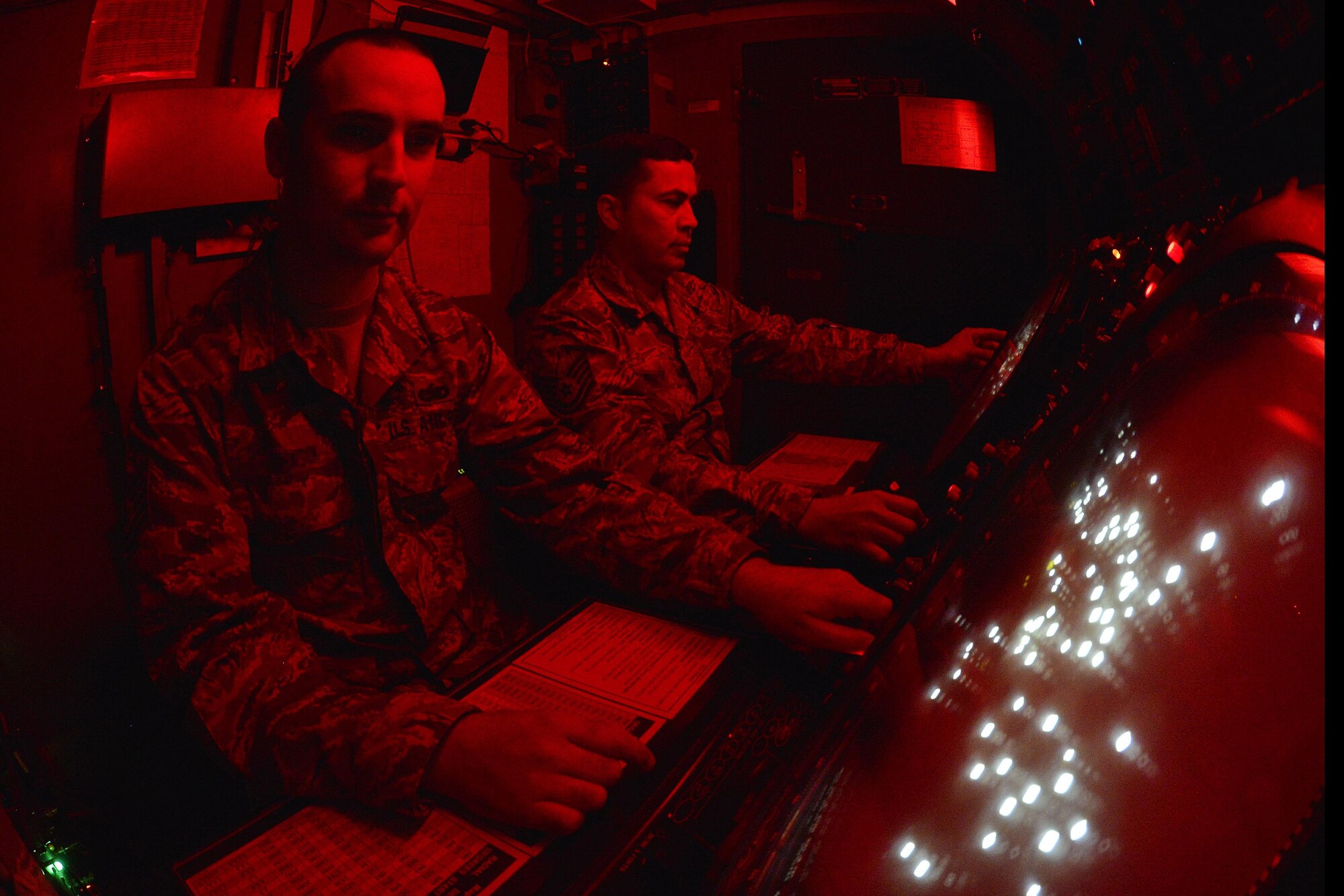 Tech. Sgt.’s Jonathan, left, and Kermit, right, verify the local display of joint and coalition targets on a planned position indicator at an undisclosed location in Southwest Asia June 29, 2015. The display is joined with others in the region to populate the air defense picture. Sgt. Jonathan is a radar craftsman and Sgt. Kermit is a radar crew chief assigned to the Expeditionary Air Control Squadron. (U.S. Air Force photo/Tech. Sgt. Christopher Boitz)
