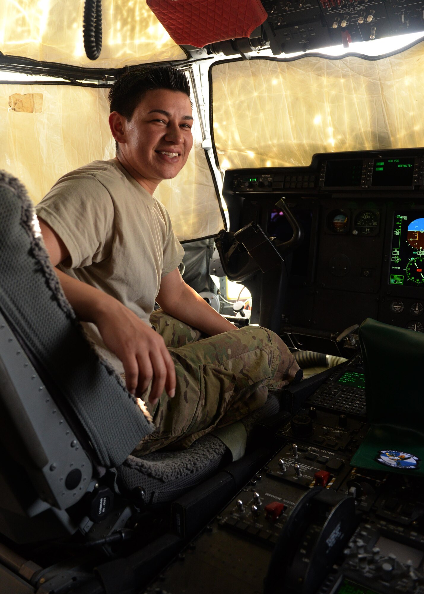 U.S. Air Force Staff Sgt. Danielle Garcia, 455th Expeditionary Aircraft Maintenance Squadron instruments and flight controls systems technician, poses for a photo in a C-130J Super Hercules aircraft July 9, 2015, at Bagram Airfield, Afghanistan. Garcia is responsible for ensuring the flight controls and navigational systems for the C-130J are updated and operational. (U.S. Air Force photo by Senior Airman Cierra Presentado/Released)