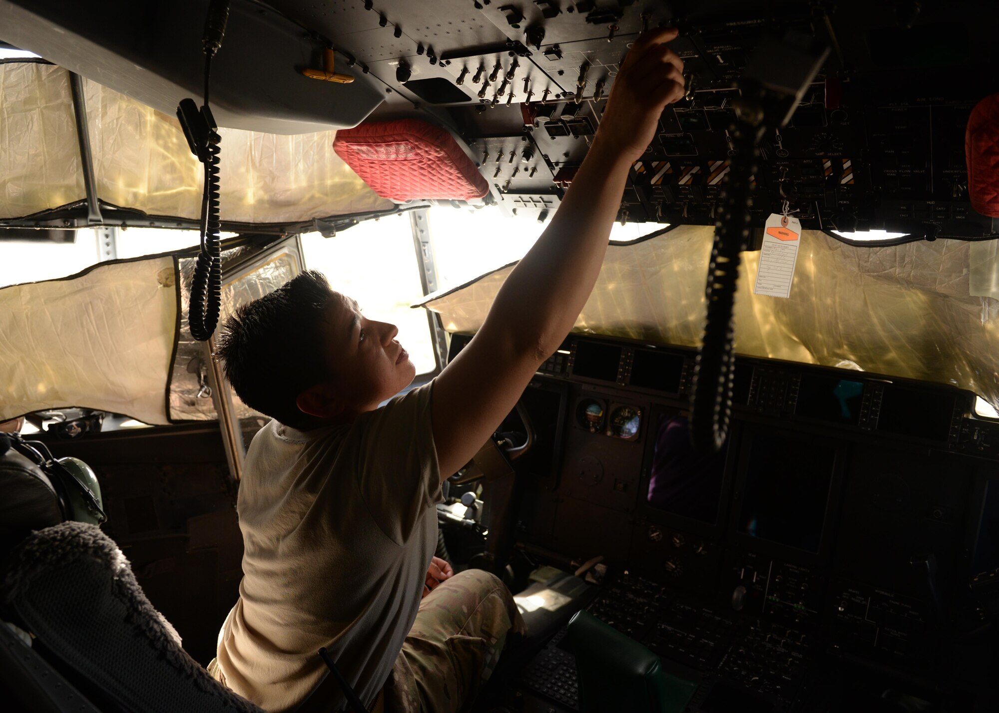 U.S. Air Force Staff Sgt. Danielle Garcia, 455th Expeditionary Aircraft Maintenance Squadron instruments and flight controls systems technician, prepares to check a navigational system in a C-130J Super Hercules aircraft July 9, 2015, at Bagram Airfield, Afghanistan. Garcia is responsible for ensuring the flight controls and navigational systems for the C-130J are updated and operational. (U.S. Air Force photo by Senior Airman Cierra Presentado/Released)