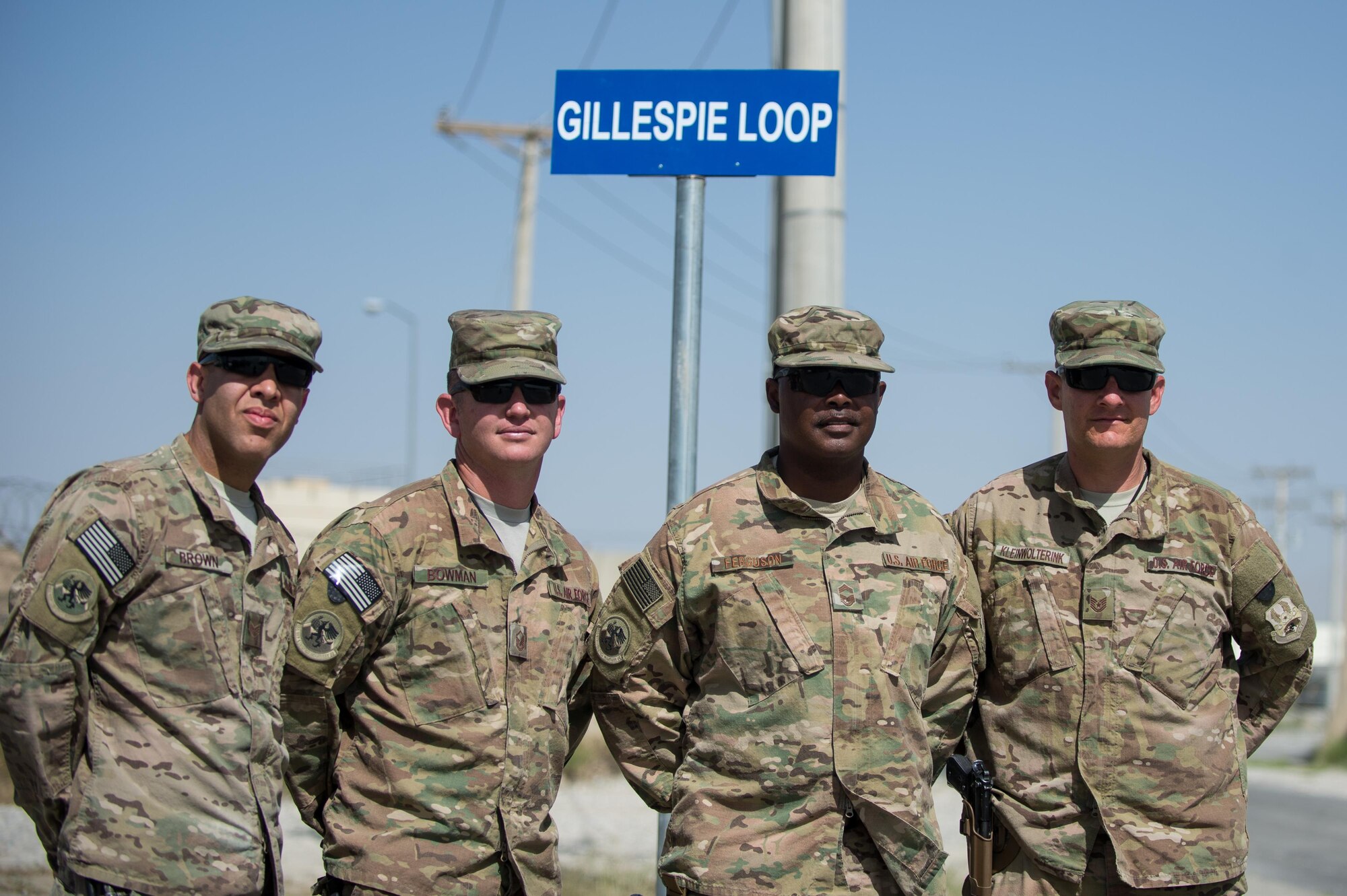 From left to right, U.S. Air Force Senior Airman Ethan Brown, Master Sgt. Jason Bowman, Chief Master Sgt. Troy Ferguson, and Tech. Sgt. Amos Kleinwolterink, all assigned to the 455th Expeditionary Logistics Readiness Squadron, stand in front of the newly unveiled Gillespie Loop sign after the Master Sgt. Randy Gillespie road dedication ceremony at Bagram Airfield, Afghanistan, July 9, 2015. Gillespie was a career fuels specialist who died July 9, 2007, from wounds sustained during small arms fire near Herat, Afghanistan. (U.S. Air Force photo by Tech. Sgt. Joseph Swafford/Released)