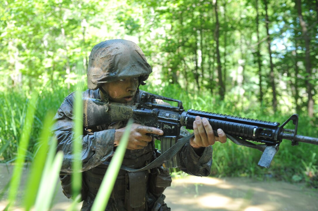 An Officer Candidate tests his courage, commitment and motivation as they navigate through the infamous Quigley water obstacle course at Officer Candidates School in Quantico, Virginia. The Quigley consists of a long canal with barbed wire and three 4-foot cement culverts submerged in swampy, snake-infested water that candidates must swim through as a part of the OCS training program.