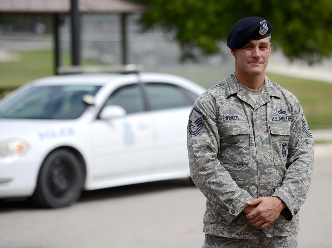 Air Force Reservist Master Sgt. Christopher Enfinger, 47th Security Forces Squadron alternate operations superintendent, poses at the 47th SFS on Laughlin Air Force Base, Texas, July 8, 2015. When not serving in his reservist capacity, Enfinger is one of only 25 officers, detectives, and sergeants assigned to the San Antonio Police Department Gang Unit who is responsible for tracking, documenting and monitoring more than 10,000 gang members and over 30 different gangs throughout San Antonio. (U.S. Air Force photo by Tech Sgt. Steven R. Doty)