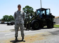 Senior Airman Daniel Dennison, 1st Special Operations Logistics Readiness Squadron vehicle operator, stands in front of a 10K all-terrain fork lift at Hurlburt Field, Fla., July 7, 2015. The Vehicle Operations flight is composed of 35 Airmen who issue government licenses and are responsible for more than 75 vehicles used for flightline operations, cargo movement, base taxi services and temporary duty Airmen at Hurlburt Field. (U.S. Air Force photo/Senior Airman Andrea Posey)