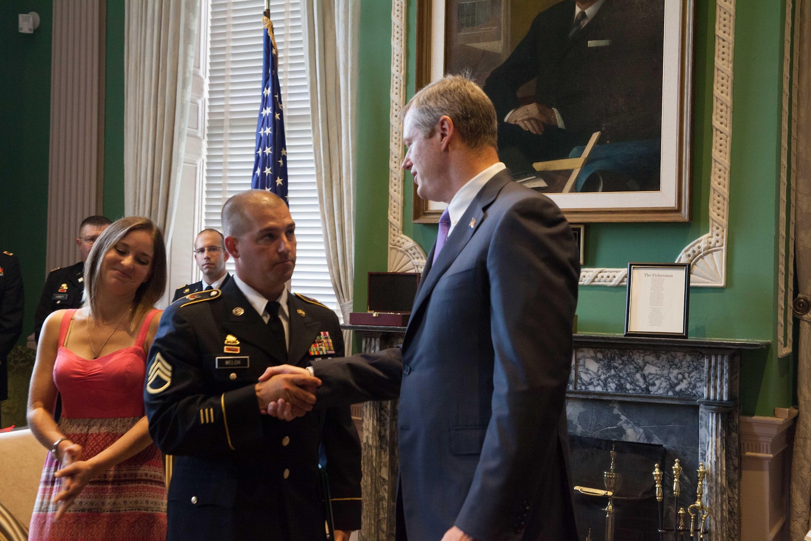 Gov. Charlie Baker awarded the Soldier's Medal to Staff Sgt. Mark Welch, Massachusetts Army National Guard, on July 8, 2015, at the State House. Baker presented the award to Welch for his heroic actions during the 2013 Boston Marathon Bombings. With Welch is his wife, Heather. (Photo by Sgt. Alfred Tripolone)