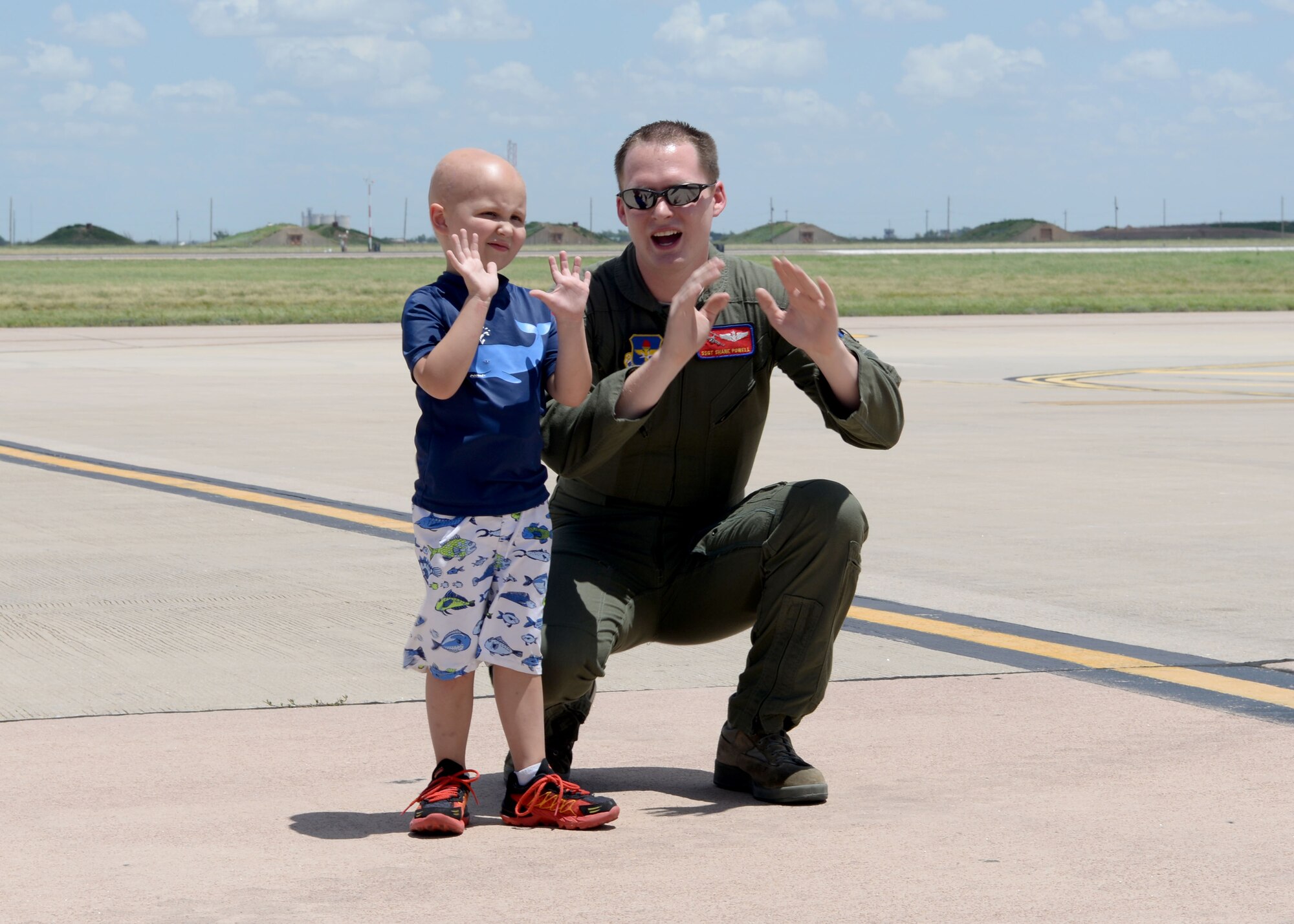 U.S. Air Force Staff Sgt. Shane Powell, 58th Airlift Squadron loadmaster, shows Jaxon Dugger how to back a truck into a U.S. Air Force C-17 Globemaster III cargo aircraft on the flightline, Altus Air Force Base, Oklahoma, June 26, 2015. Ewing’s sarcoma is a cancer found primarily in the bones and soft tissue, but Jaxon is of two percent of those with it found in his brain. (U.S. Air Force photo by Airman 1st Class Kirby Turbak)