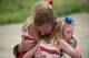 Capt. Ross Farling, a C-130 Hercules pilot from the 123rd Airlift Wing, hugs his daughters during a homecoming ceremony at the Kentucky Air National Guard Base in Louisville, Ky., July 4, 2015. Farling was among 39 guardsmen who returned from a deployment to the Persian Gulf region, where they supported Operation Freedom's Sentinel. (U.S. Air National Guard photo/Maj. Dale Greer)