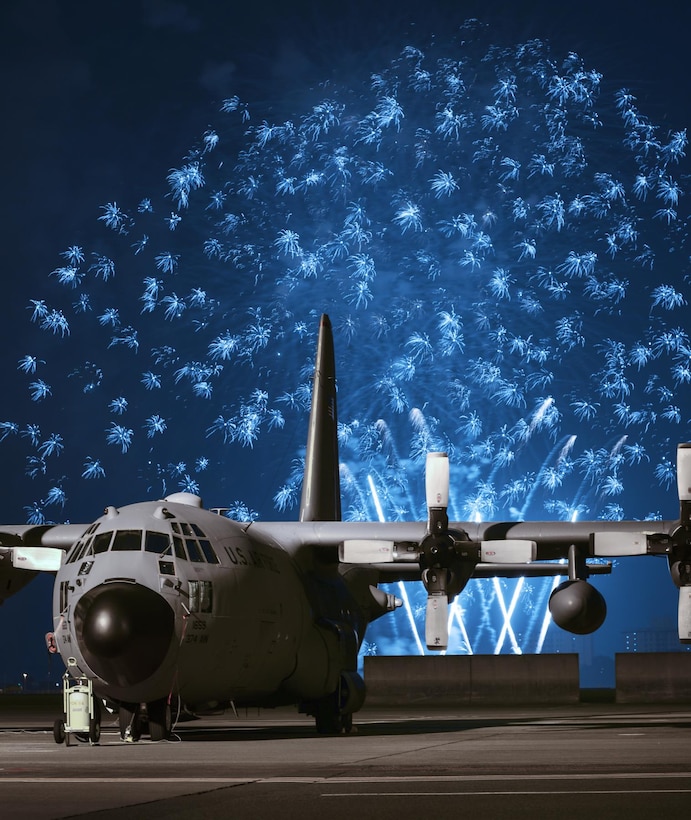 Fireworks explode behind a C-130 Hercules during Celebrate America, July 2, 2015, at Yokota Air Base, Japan. Celebrate America is an annual event that provides military members and their families the opportunity to enjoy games, food and bands before culminating in a fireworks display to celebrate Independence Day. (U.S. Air Force photo/Airman 1st Class Delano Scott)