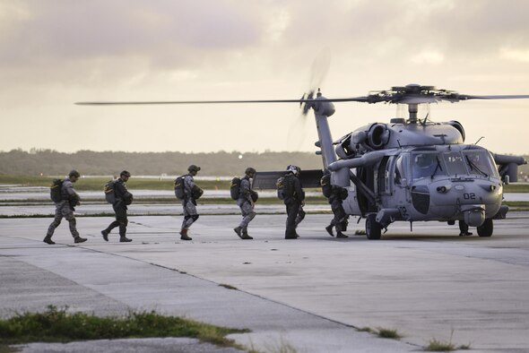Members of the 736th Security Forces Squadron board an MH-60 Sierra, assigned to Helicopter Sea Combat Squadron 25, July 3, 2015, at Andersen Air Force Base, Guam. HSC-25 provides vital airlift support to the 736th SFS, assisting with their quarterly static line parachute operations. (U.S. Air Force photo/Senior Airman Katrina M. Brisbin)