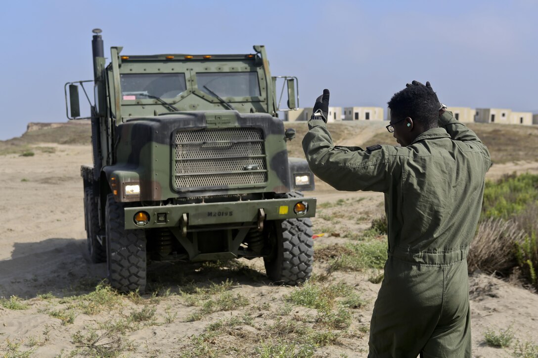 U.S. Marine Medium Tactical Vehicle Replacement is loaded onto U.S. Navy Landing Craft Air Cushioned (LCAC) vehicle from Assault Craft Unit 5 on Red Beach as part of a loading exercise along side Combat Logistics Battalion 11, Headquarters Regiment, 1st Marine Logistics Group aboard Camp Pendleton, Calif., June 23, 2015. This loading exercise reinforces the Marine Corps role as an amphibious force in readiness by maintaining capabilities through realistic training.(U.S. Marine Corps photo by Lance Cpl. Lauren Falk/Released)