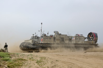 U.S. Navy Landing Craft Air Cushioned (LCAC) vehicle from Assault Craft Unit 5 lands on Red Beach as part of a loading exercise along side Combat Logistics Battalion 11, Headquarters Regiment, 1st Marine Logistics Group aboard Camp Pendleton, Calif., June 23, 2015. This loading exercise reinforces the Marine Corps role as an amphibious force in readiness by maintaining capabilities through realistic training. (U.S. Marine Corps photo by Lance Cpl. Lauren Falk/Released)
