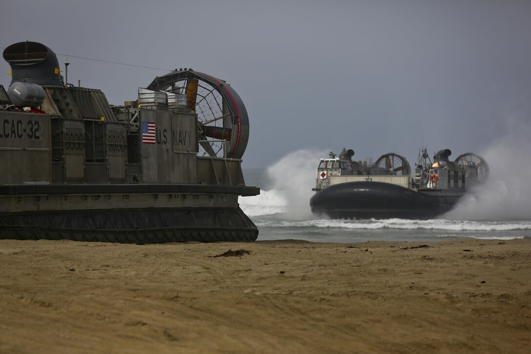 U.S. Navy Landing Craft Air Cushioned (LCAC) vehicle from Assault Craft Unit 5 lands on Red Beach as part of a loading exercise along side Combat Logistics Battalion 11, Headquarters Regiment, 1st Marine Logistics Group aboard Camp Pendleton, Calif., June 23, 2015. This loading exercise reinforces the Marine Corps role as an amphibious force in readiness by maintaining capabilities through realistic training. (U.S. Marine Corps photo by Lance Cpl. Lauren Falk/Released)