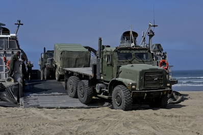A Landing Craft Air Cushioned vehicle from Assault Craft Unit 5 unloads a Medium Tactical Vehicle Replacement onto Red Beach as part of a loading exercise along side Combat Logistics Battalion 11, Headquarters Regiment, 1st Marine Logistics Group, aboard Camp Pendleton, Calif., June 23, 2015. This loading exercise reinforces the Marine Corps' role as an amphibious force in readiness by maintaining capabilities through realistic training.(U.S. Marine Corps photo by Lance Cpl. Lauren Falk/Released)
