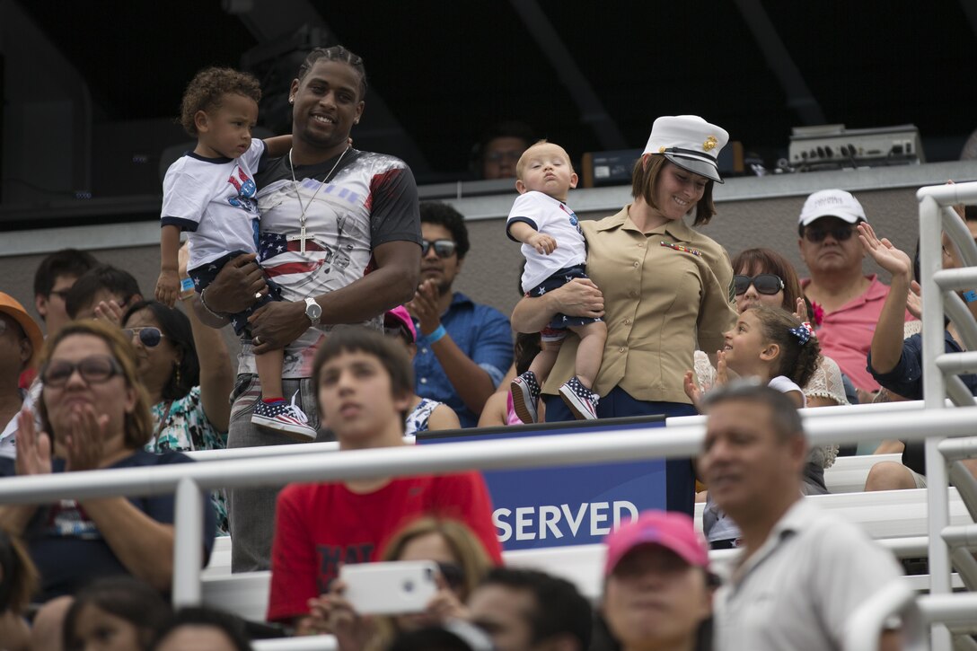 Sgt. Jennifer Quinn, Marine Aircraft Group (MAG) 11 operations chief, stands with her family at the Shamu Stadium at SeaWorld San Diego, July 4. Quinn was one of the Marines from the 3rd Marine Aircraft Wing scheduled to make an appearance during Waves of Honor, a time SeaWorld dedicates to military members worldwide.