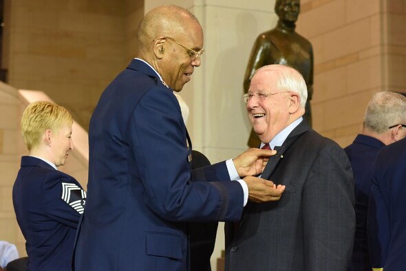 Air Force Vice Chief of Staff Gen. Larry O. Spencer pins a commemorative Vietnam veteran lapel pin on retired Col. William Driggers Jr. during the Congressional Commemoration of the 50th Anniversary of the Vietnam War July 8, 2015, in the Emancipation Hall of the U.S. Capitol in Washington. (U.S. Air Force photo/Staff Sgt. Carlin Leslie)