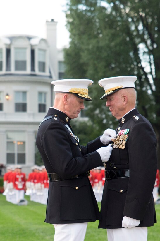 Gen. Joseph Dunford Jr., commandant of the Marine Corps, presents a Distinguished Service Medal to Lt. Gen. Steven Hummer during his retirement ceremony at Marine Barracks Washington, D.C., July 9, 2015. Hummer retired after 41 years of faithful service to the Marine Corps and after serving as the Deputy to the Commander for Military Operations, US Africa Command from June 2013-2015. (U.S. Marine Corps Photo by Cpl. Chi Nguyen/Released)