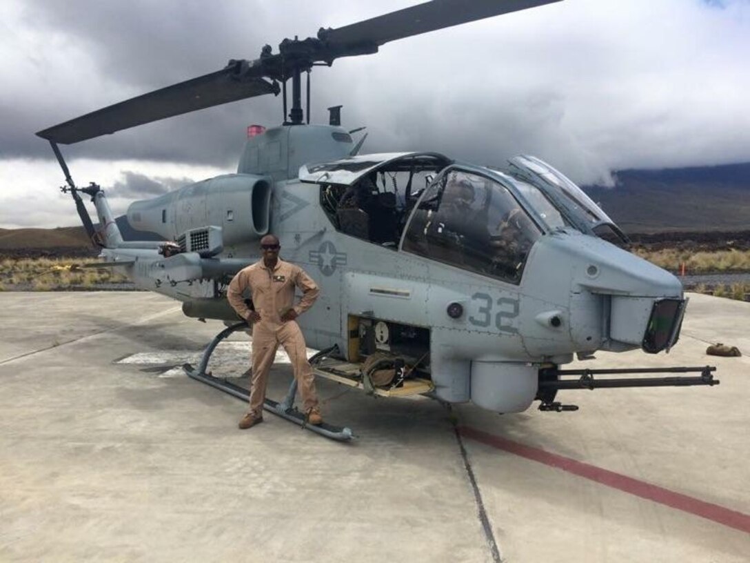 Gunnery Sgt. Jimi Khamisi, a section leader with Marine Wing Support Squadron 374, stands with an AH-1 Cobra before deploying to Pohakuloa Training Area at the Island of Hawaii. Khamisi is a practicing Muslim who recently engaged in a ceremony to celebrate Ramadhan at Joint Base Pearl Harbor-Hickam.