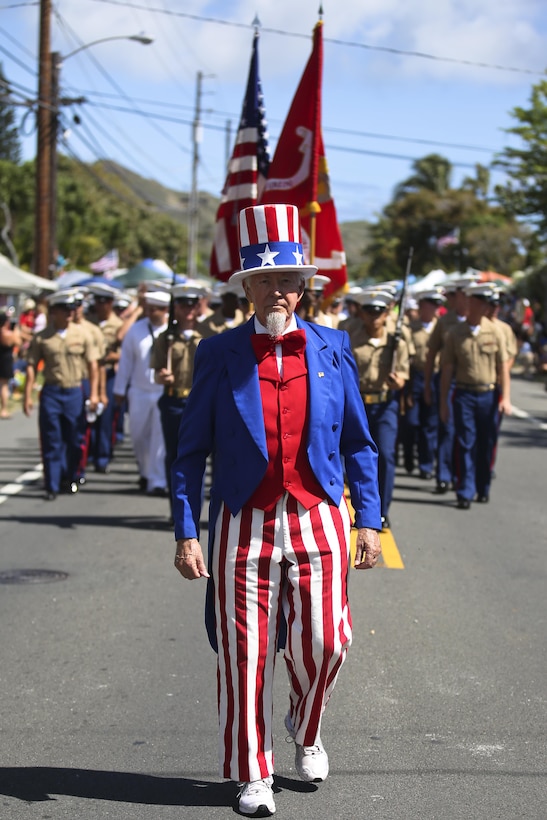 Dressed as Uncle Sam, retired Army Lt. Col. Darrell Strong leads the 3rd Marine Regiment during the 69th Annual Kailua Independence Day Parade, July 4, 2015. The parade includes local politicians and dignitaries, military and veteran units, community and federal groups, as well as bands, including the Royal Hawaiian Band and the Kukui High School Alumni Marching Band. The parade provided an opportunity for people to celebrate Independence Day and show their support for the local community. (U.S. Marine Corps photo by Lance Cpl. Harley Thomas/Released)