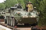 Soldiers with P Troop, 4th Squadron, 2nd Stryker Cavalry Regiment download Stryker armored vehicles and other military equipment from a railhead June 30, 2015 in Nowa Deba, Poland. The troop, based out of Vilsek, Germany, arrived with approximately 20 Stryker vehicles to begin several weeks of training with the Polish 6th Airborne Brigade. The Soldiers are participating in Atlantic Resolve, an ongoing multinational partnership.