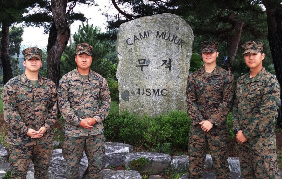 – Lance Cpl. Paul J. Yi (right), chemical, biological, radiological and nuclear defense specialist with 4th Light Armored Reconnaissance Battalion, 4th Marine Division, stands in front of the Camp Mujuk sign with Marines attached to Task Force 2/24 as interpreters during Peninsula Express 15 aboard Camp Mujuk, Republic of Korea, July 10, 2015. Peninsula Express is this year’s eighth iteration of the Korean-Marine Exchange Program, a series of exercises between the U.S. and Republic of Korea Marine Corps designed to build interoperability and tactical familiarity between the partner nations. (Courtesy photo)