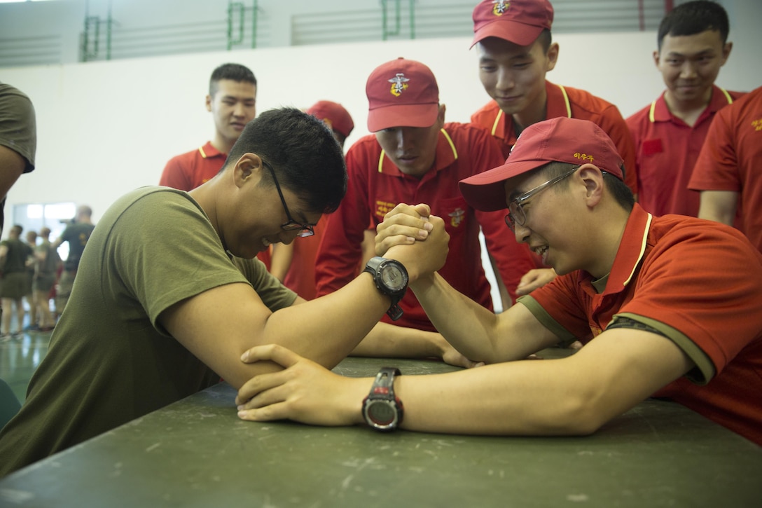 Lance Cpl. Paul J. Yi, chemical, biological, radiological and nuclear defense specialist with 4th Light Armored Reconnaissance Battalion, 4th Marine Division, arm wrestles Cpl. Min Wook Yoo, an infantryman with 5th Company, 2nd Battalion, 7th Regiment, 1st Marine Division, at warrior day during Peninsula Express 15 in Pohang, Republic of Korea, July 8, 2015. Both Yi and Woo served as interpreters for the exercise. Peninsula Express is this year’s eighth iteration of the Korean-Marine Exchange Program, a series of exercises between the U.S. and Republic of Korea Marine Corps designed to build interoperability and tactical familiarity between the partner nations. (U.S. Marine Corps photo by Cpl. Ian Leones)