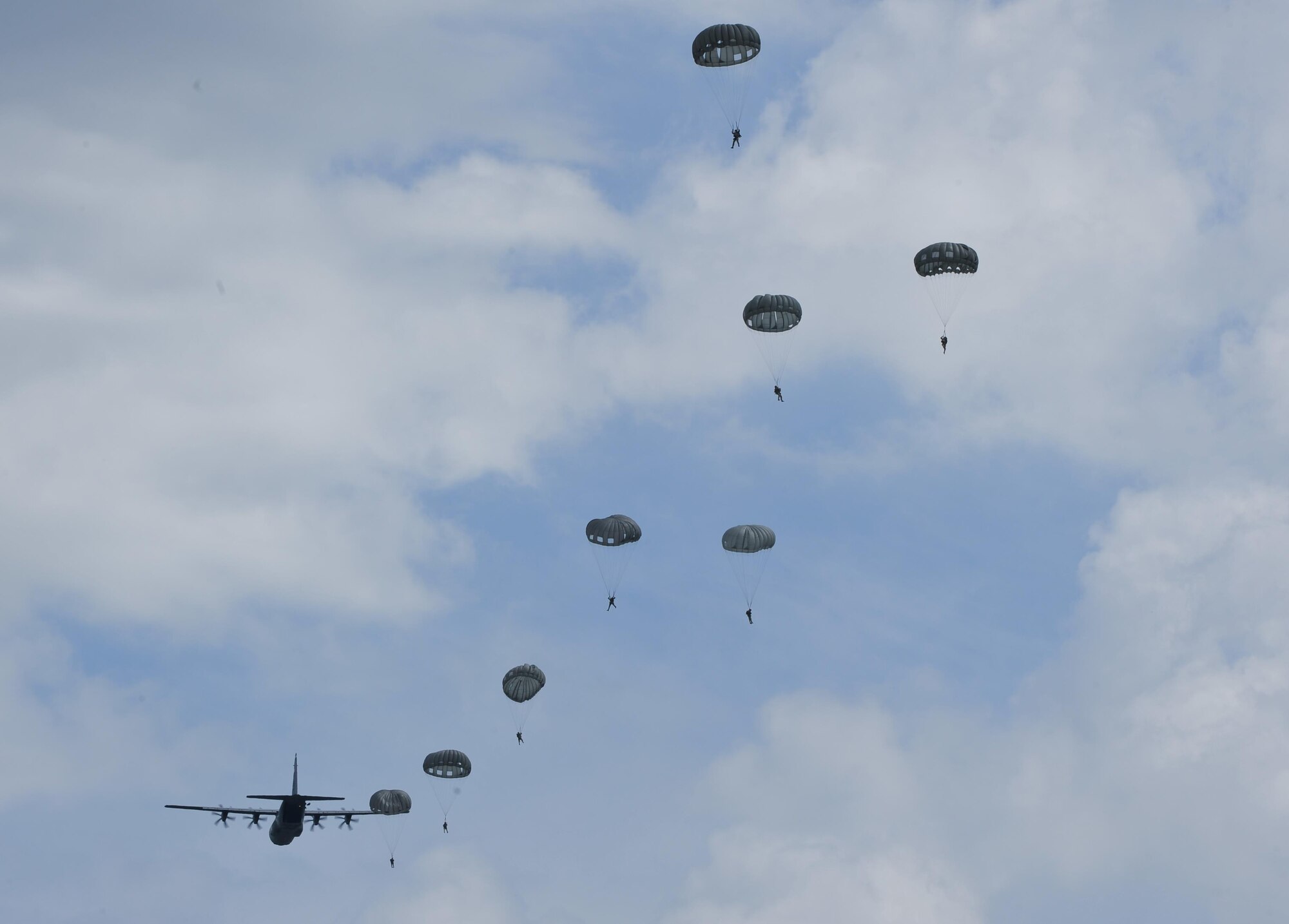Paratroopers exit a C-130J Super Hercules during International Jump Week near Alzey, Germany, July 7, 2015. During jump week, more than 200 U.S. and allied partners disembarked their designated airframes to strengthen skills and tactics, while building and strengthening international relations with counterparts. (U.S. Air Force photo/Staff Sgt. Leslie Keopka) 