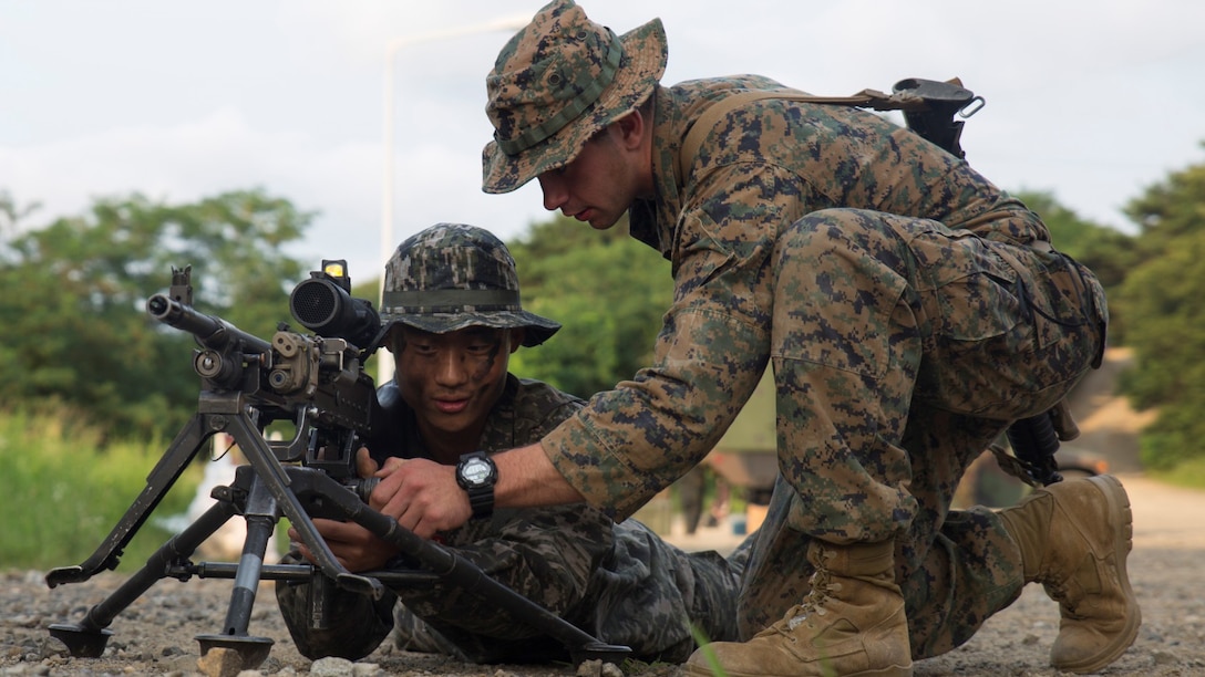 Corporal Lucas G. Hubanks (right) with Company G, 2nd Battalion, 24th Marine Regiment shows Cpl. Sang Kyung Park, a machine gunner with 6th Company, 2nd Battalion, 7th Regiment, ROK Marines, how to sight in with the M240B machine gun during Peninsula Express 15-8 in Pohang, Republic of Korea, July 4, 2015. Peninsula Express is the eighth iteration this year of the Korean-Marine Exchange Program and the first time Marine Forces Reserve has participated in the series of exercises between the U.S. and Republic of Korea Marine Corps designed to build interoperability and tactical familiarity between partner nations.