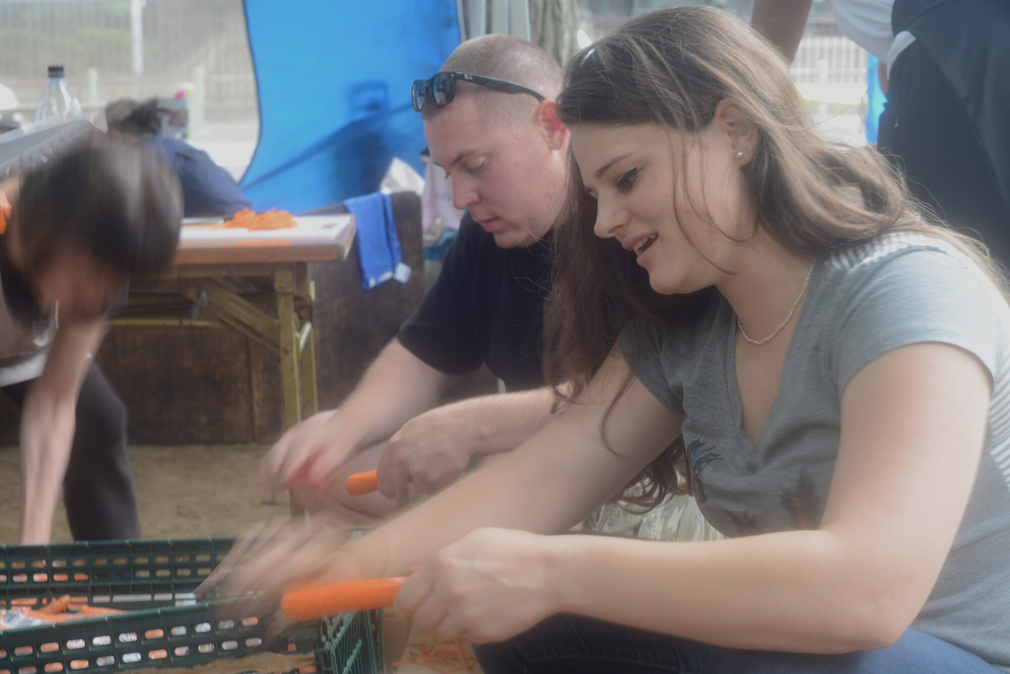 Elizabeth Baker peels carrots used to feed homeless men and women at Ueno Park, Tokyo Japan, June 26, 2015. While Yokota Air Base's participation in homeless outreach events is run by the base chapel, members from all religious denominations are welcome to volunteer. (U.S. Air Force photo by Airman 1st Class David C. Danford/Released)