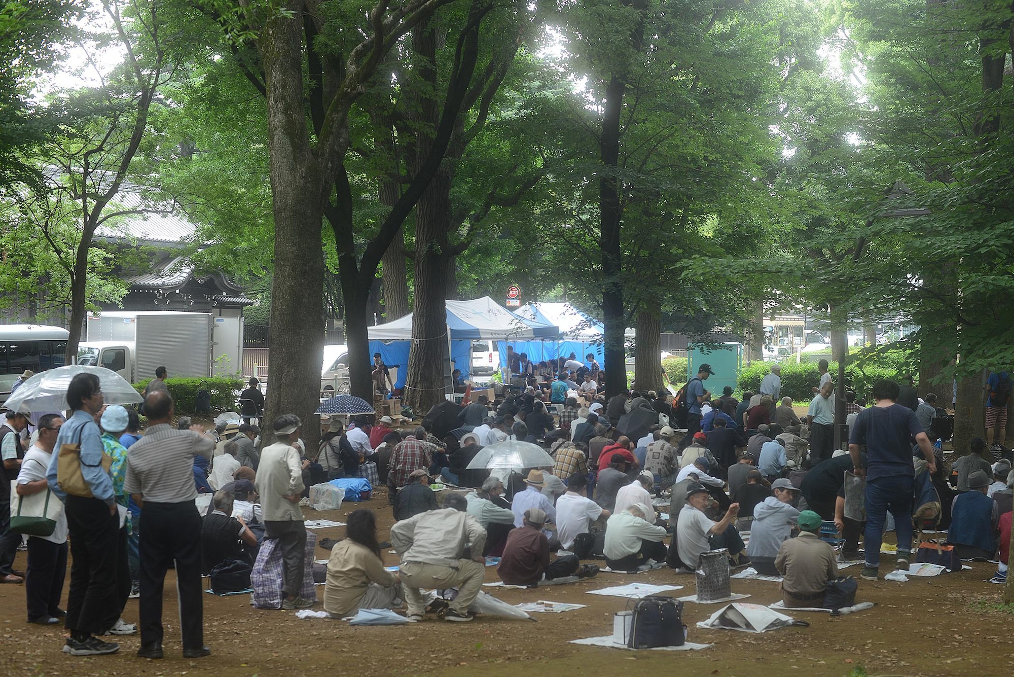 Homeless men and women gather to receive meals prepared by volunteers from Yokota Air Base, Japan, and members of a local church at Ueno Park, Tokyo Japan, June 26, 2015. More than 400 people are fed at each homeless outreach event. (U.S. Air Force photo by Airman 1st Class David C. Danford/Released)