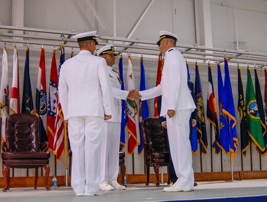 U.S. Navy Capt. David E. Koss, center, commodore, Strike Fighter Wing, U.S. Pacific Fleet, presides over the transfer of leadership during Strike Fighter Squadron (VFA) 101’s change of command ceremony, July 2, 2015, on Eglin Air Force Base, Florida. During the ceremony, Cmdr. James D. Christie relieved Capt. Frederick E. Crecelius as the commanding officer of VFA-101, the first F-35C Lightning II squadron in the Navy. (U.S. Navy courtesy photo)