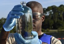 Staff Sgt. Anthony McCullan, 1st Special Operations Logistics Readiness Squadron fuels laboratory technician NCO in charge, conducts a visual inspection of a jet fuel sample during a fuel receipt at Hurlburt Field, Fla., June 25, 2015. Samples are taken to verify quality assurance of the fuel. (U.S. Air Force photo/Airman Kai White/Released)