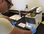 Senior Airman Johnathan Morgan, 1st Special Operations Logistics Readiness Squadron fuel laboratory technician, tests the flash point of a fuel sample at Hurlburt Field, Fla., June 25, 2015. Flash-point testing verifies the temperature at which the fuel combusts. (U.S. Air Force photo/Airman Kai White/Released) 