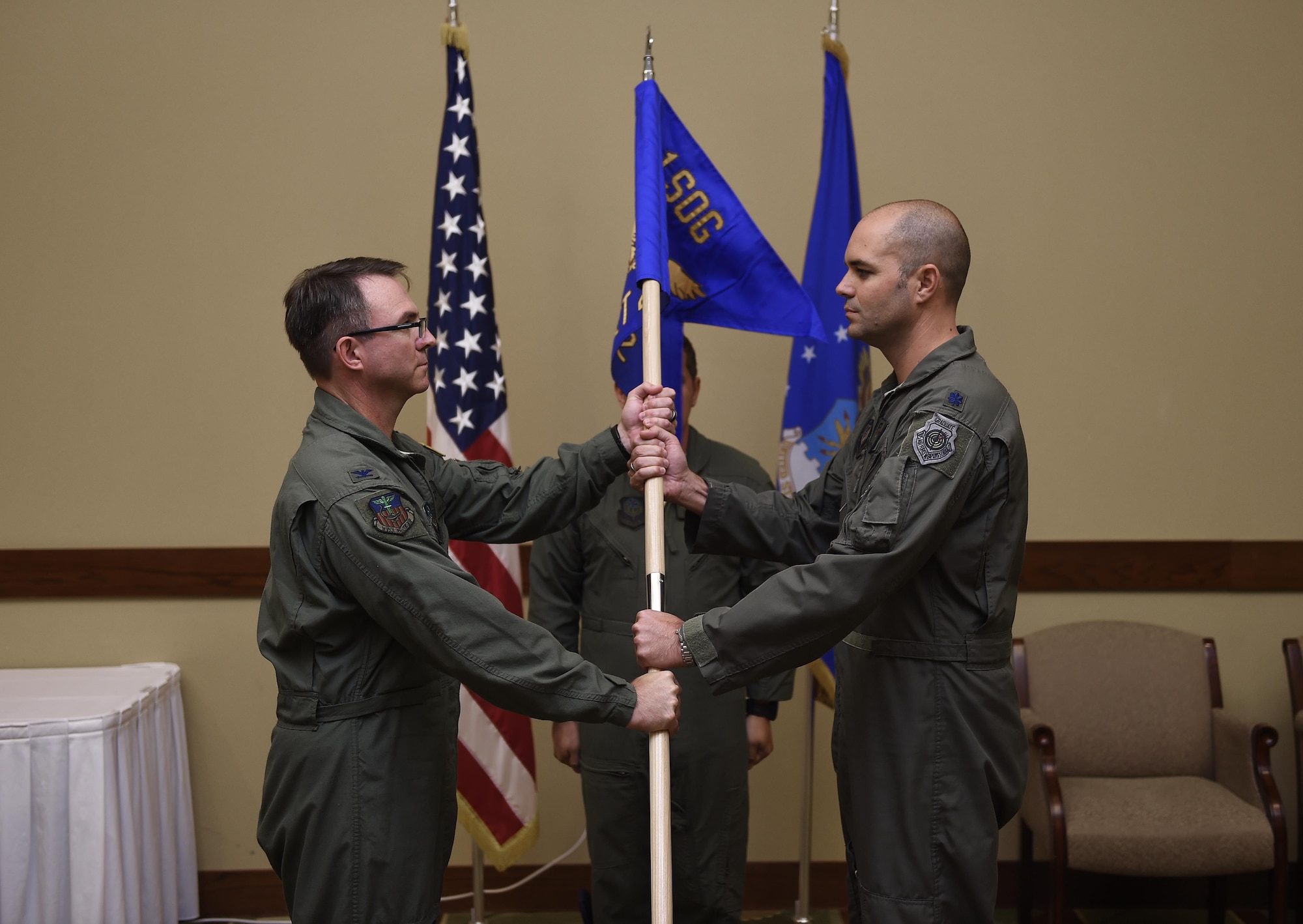 Col. Stewart Hammons, 1st Special Operations Group commander, passes the Detachment 2 guidon to Lt. Col. Bret DeAngelis, DET 2 commander, during an activation ceremony at the Hurlburt Field, Fla., July 10, 2015. DET 2 was activated to operationally test the AC-130J Ghostrider gunship, train aircrews, as well as develop new tactics, techniques and procedures for the aircraft. (U.S. Air Force photos by Airman Kai White/Released)