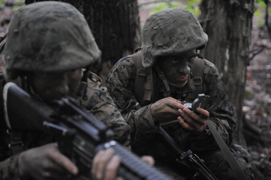 Officer Candidates navigate through the dense woods of Quantico during a small unit leader evaluation evolution. The evaluation tests the candidates' physical, mental and, most importantly, leadership skills necessary and required of all Marine officers before they are commissioned as second lieutenants.