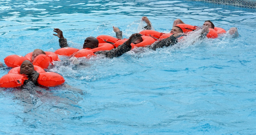 Crew members from the 1 – 228th Aviation Regiment practice basic swimming strokes during a water survival training course July 9, 2015, at Soto Cano Air Base, Honduras. Joint Task Force-Bravo regularly receives calls to help with search and rescue missions, sometimes over water. (U.S. Air Force photo by Staff Sgt. Jessica Condit) 
