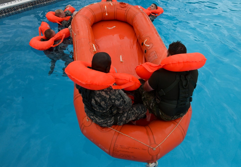 Crewmembers from the 1 – 228th Aviation Regiment practice the proper procedures for entering a life raft during water survival training July 9, 2015, at Soto Cano Air Base, Honduras. The Joint Task Force-Bravo Personnel Recovery office hosted the training to ensure the crewmembers learn vital skills necessary for survival and rescue in the event of a water evacuation from a helicopter. (U.S. Air Force photo by Staff Sgt. Jessica Condit)