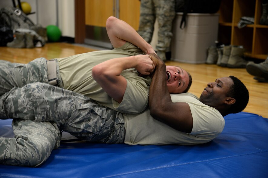Senior Airman Angelo Neely, 47th Security Forces Squadron combat arms instructor , applies a ‘rear restraint’ on Senior Airman Jacob Eckert, 47 SFS combat arms instructor, in Losano Fitness Center on Laughlin Air Force Base, Texas, July 10, 2015. Advanced restraint applications like the ‘rear restraint’ are applied when it is necessary to immediately terminate any situation that may involve a struggle. It is used in extreme cases when the individual is dangerous and when self-defense is an absolute necessity. (U.S. Air Force photo by Airman 1st Class Brandon May)(Released)
